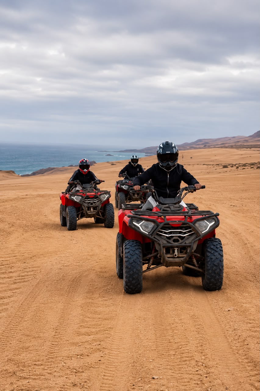 Four people riding red quad bikes on a dirt road. — Timlaline / Timlalin dunes quad tour photo, Agadir Morocco