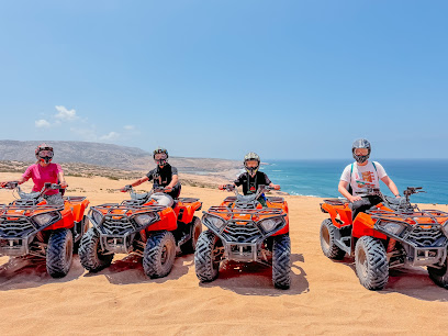 Four people on orange quad bikes in front of a beach. — Timlaline / Timlalin dunes quad tour photo, Agadir Morocco